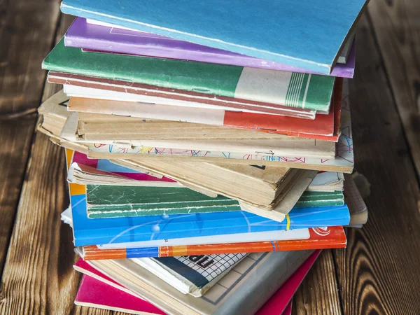 Rough pile of old vintage books on a wooden table — Stock Photo, Image