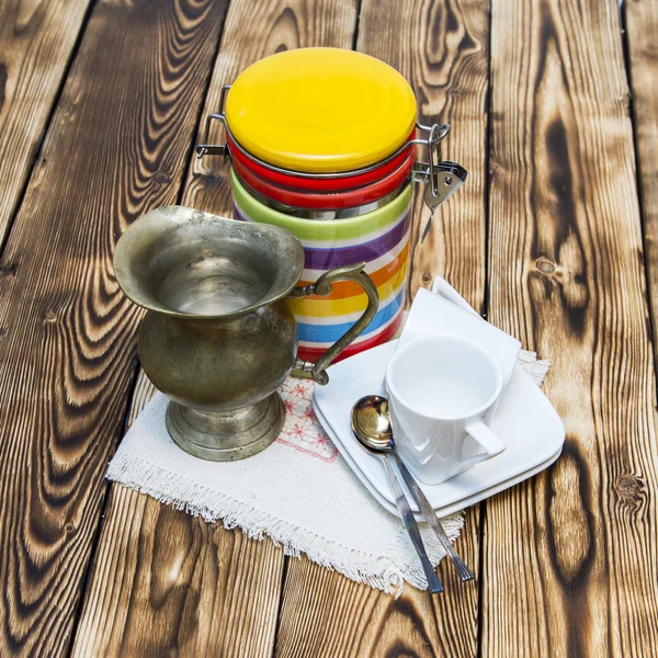 Cup of coffee of espresso and ancient metal small jug for milk — Stock Photo, Image