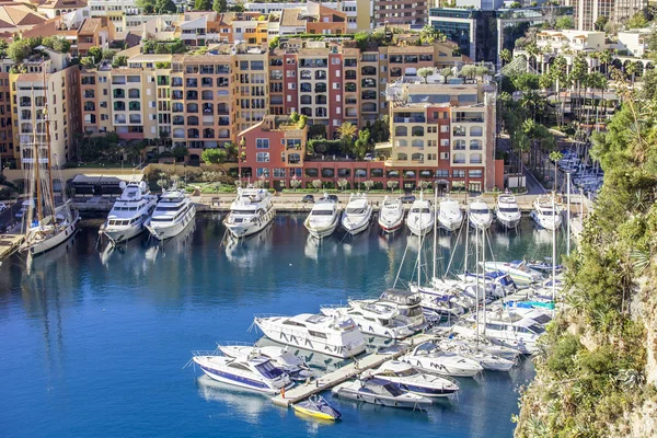 MONTE-CARLO, MONACO, on JANUARY 10, 2016. A view of houses on a slope of the mountain and yachts on the bay Stock Picture