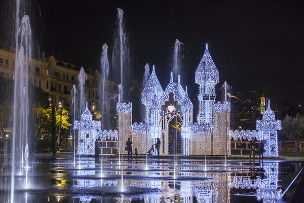 NICE, FRANCE - on JANUARY 8, 2016. The flat fountain and Christmas constructions in Promenade du Paillon park. Night look.