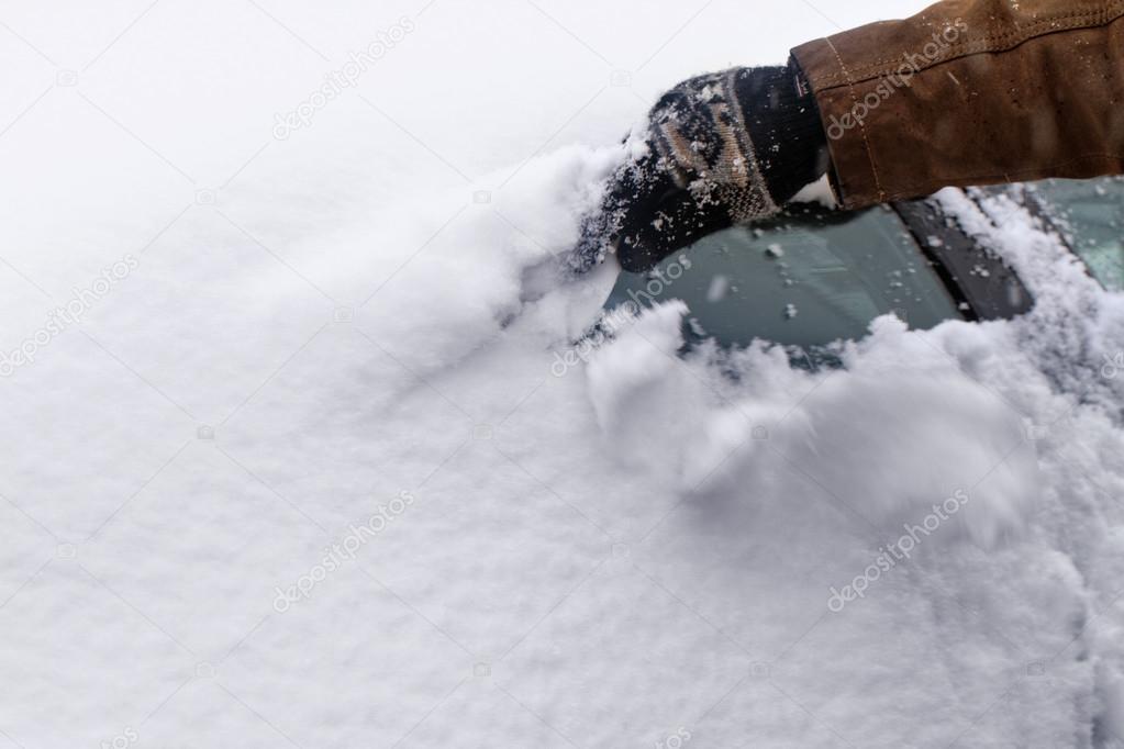 Man scraping snow