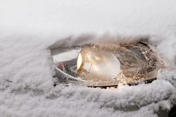 Car's snowy headlight — Stock Photo, Image