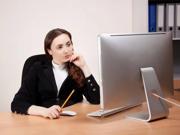 Businesswoman working on her computer Stock Picture