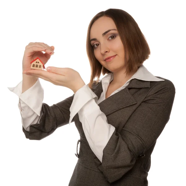 Businesswoman holding toy house in her hand — Stock Photo, Image