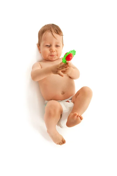 Adorable baby with toy lying on floor — Stock Photo, Image