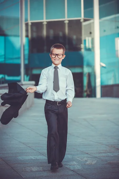 Kid businessman is waving his jacket — Stock Photo, Image