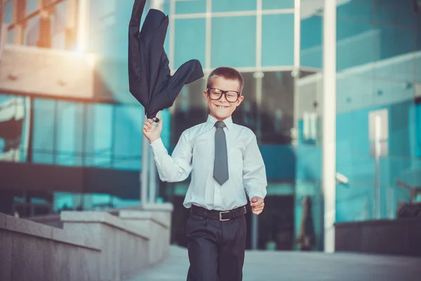 Kid businessman is waving his jacket — Stock Photo, Image