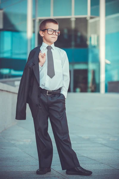 Kid businessman on the blue modern background — Stock Photo, Image