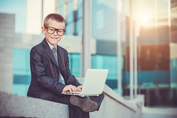 Happy kid businessman with laptop — Stock Photo, Image