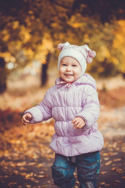 Happy playful baby in the autumn park — Stock Photo, Image