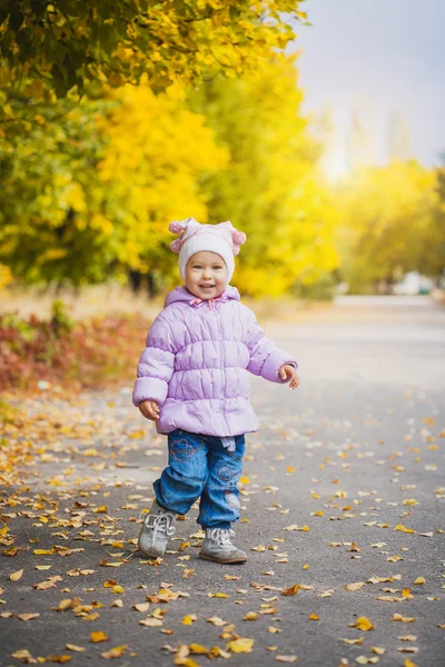 Bebê brincalhão feliz está correndo no parque de outono — Fotografia de Stock