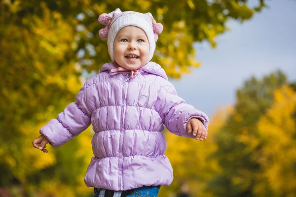 Happy playful baby in the autumn park — Stock Photo, Image