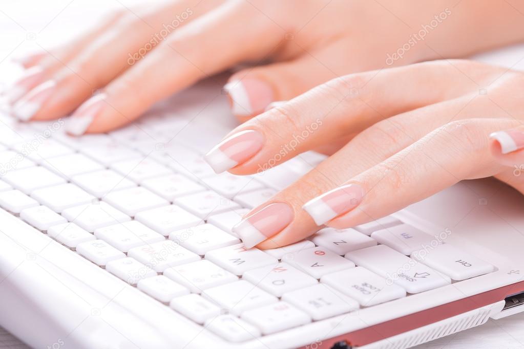 Hands of an office woman typing