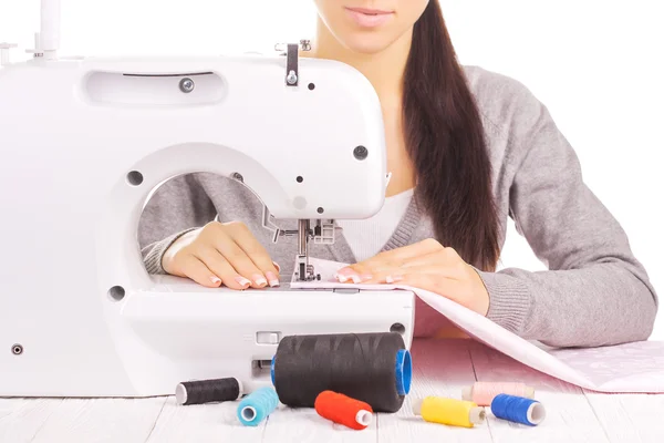 Happy seamstress sewing. isolated on the white — Stock Photo, Image