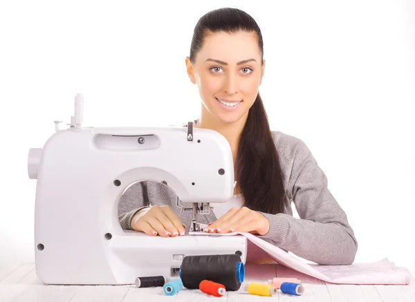 Happy seamstress sewing. isolated on the white — Stock Photo, Image