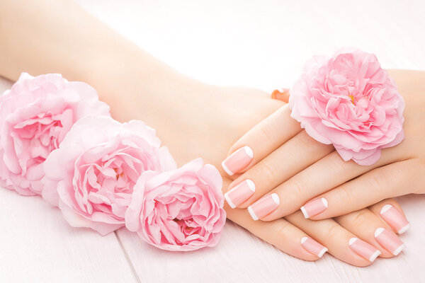french manicure with rose flowers. spa