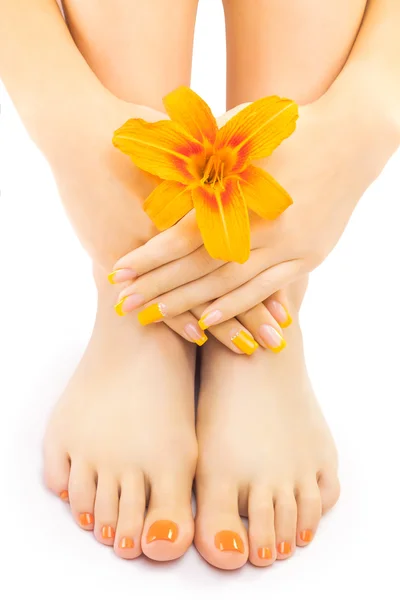 Pedicure met een oranje lily bloem ontspannen — Stockfoto