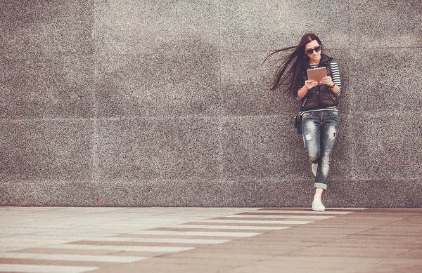 Girl with tablet is walking in the downtown — Stock Photo, Image