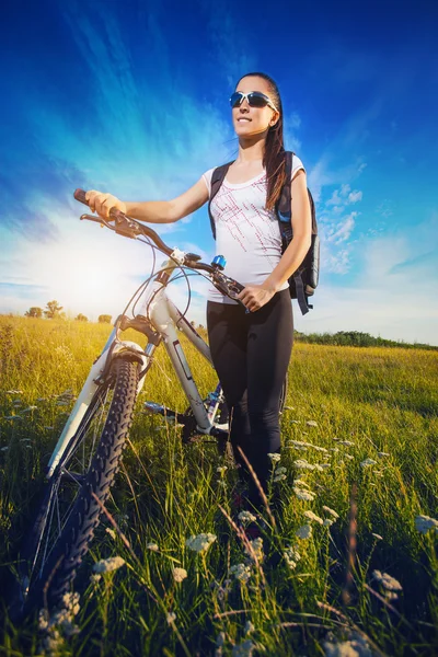 Woman is riding bicycle outside — Stock Photo, Image