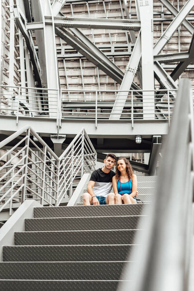 Young couple on an industrial staircase