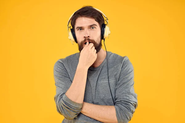 Man met koptelefoon muziek lifestyle lifestyle technologie gele achtergrond — Stockfoto