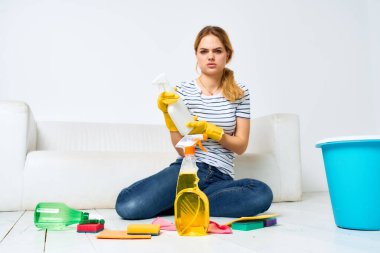 Temizlikçi kadın, ellerinde deterjanla oda temizlikçisi.