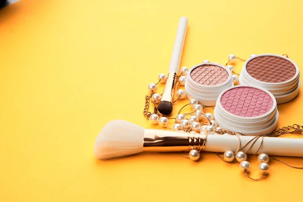 Eyeshadows on a yellow background professional cosmetics makeup brushes soft sponge fashion glasses — Stock Photo, Image