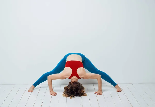 Sportive woman doing exercises on the floor yoga asana meditation — Stock Photo, Image