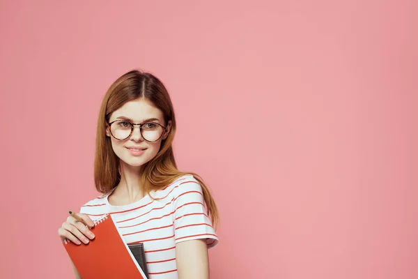 Beautiful female student holding books education institute gesturing with hands pink background Copy Space — Stock Photo, Image