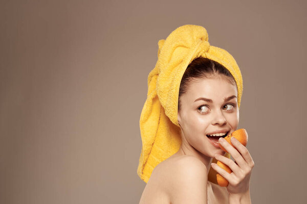 Cheerful woman with oranges in her hands clean skin spa treatments. High quality photo