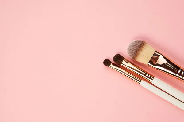 Pinceles de maquillaje y cosméticos profesionales sombra de ojos sobre fondo rosa —  Fotos de Stock