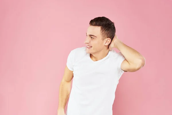 Cheerful handsome man in white t-shirt emotions pink isolated background — Stock Photo, Image