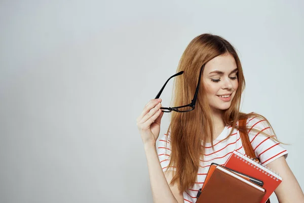 Female student with notepad and backpack on back cropped view education science glasses — Stock Photo, Image