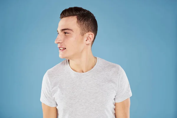 Emotionaler Mann in weißem T-Shirt schneidet Blick auf blauem Hintergrund ab — Stockfoto