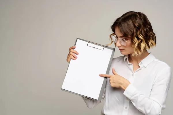 Femme d'affaires avec dossier de documents dans les mains sur fond gris vue recadrée du travail — Photo