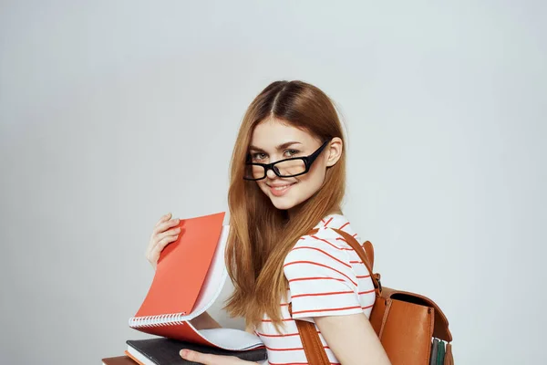 Female student with notepad and backpack on back cropped view education science glasses — Stock Photo, Image