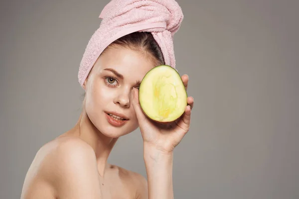 stock image Smiling woman with bare shoulders with towel on head Mango in hand cropped view