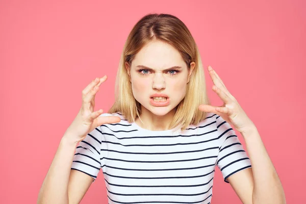 Blonde gestreifte T-Shirt Emotion Geste Hände unzufrieden Gesichtsausdruck rosa Hintergrund — Stockfoto