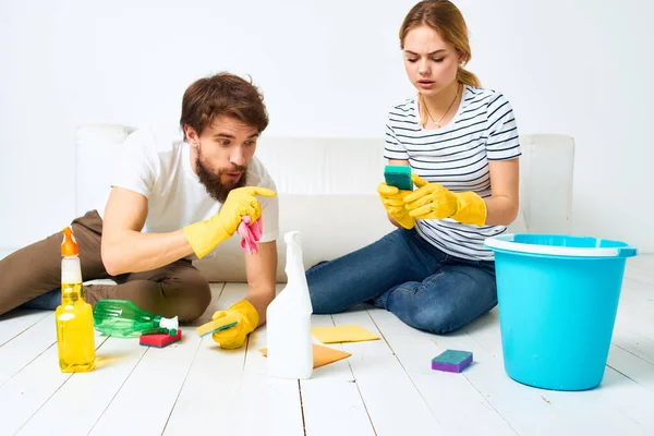 Man and woman washing floors cleaning supplies interior teamwork — Stock Photo, Image