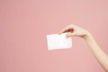 Pembe arka planda paketler içinde uzanmış. Hijyen öngörüsü temiz.