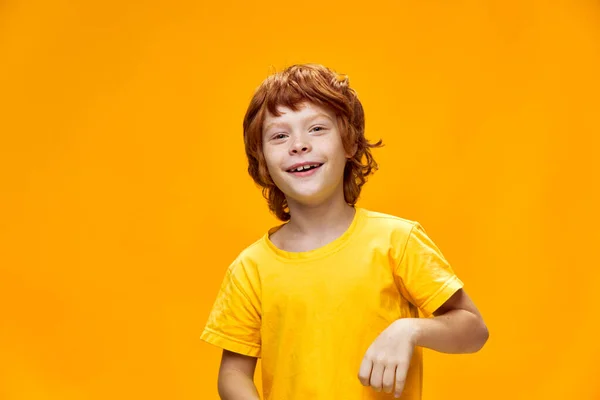Lustiger rothaariger Junge, der vor isoliertem Hintergrund lächelt und nach vorne blickt — Stockfoto