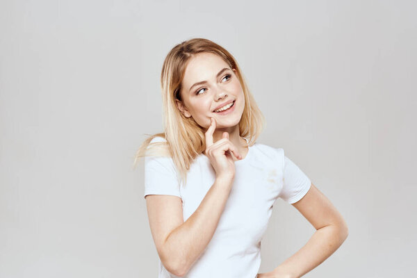 Cute blonde white t-shirt gesture with hands lifestyle light background