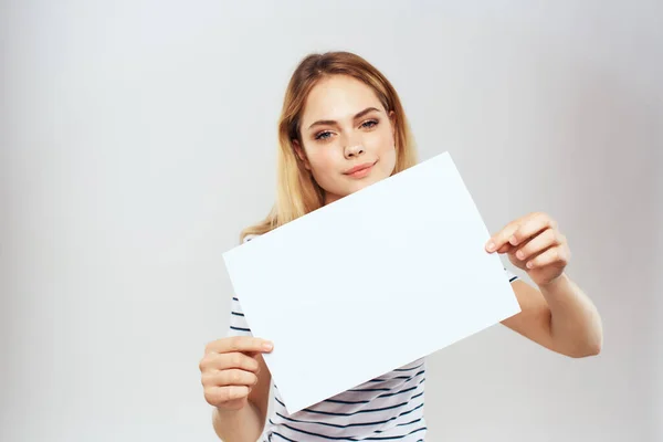 Woman holding a sheet of paper in her hands lifestyle striped t-shirt cropped view Copy Space — Stock Photo, Image