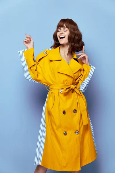 Fashion woman Wide smile closed eyes gesture with fingers yellow striped coat