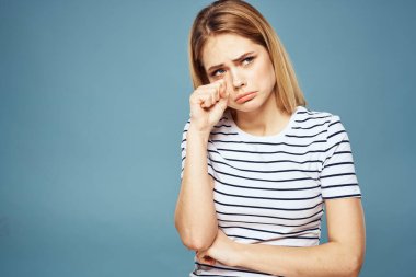 Çizgili tişört giyen bir kadın. Kırpılmış manzara. Mavi izole edilmiş arka plan.