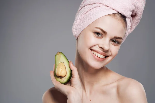 stock image Pretty woman clean skin avocado in hand health cosmetics procedure