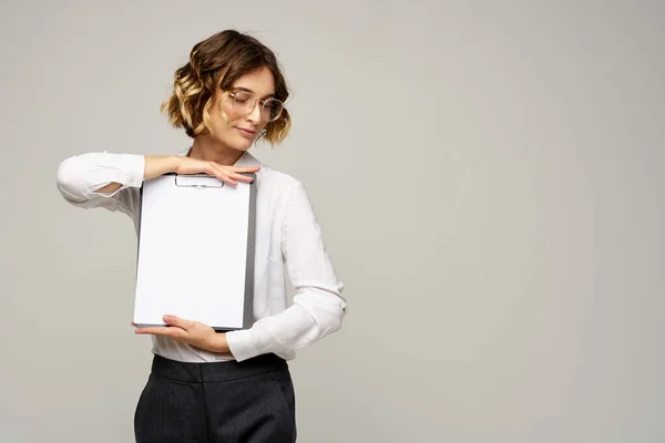 Business woman with folder of documents in hands on gray background cropped view of work — Stock Photo, Image