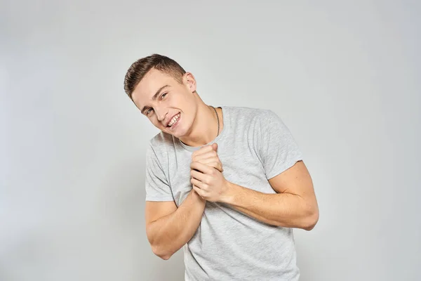 Handsome man in light t-shirt cropped view emotion studio isolated background — Stock Photo, Image