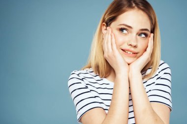 Çizgili tişörtlü sarışın kız yaşam tarzı mavi arka plan eğlencesi