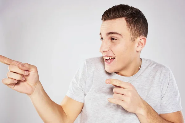 Man in a white t-shirt emotions gestures with hands close-up cropped view light background — Stock Photo, Image